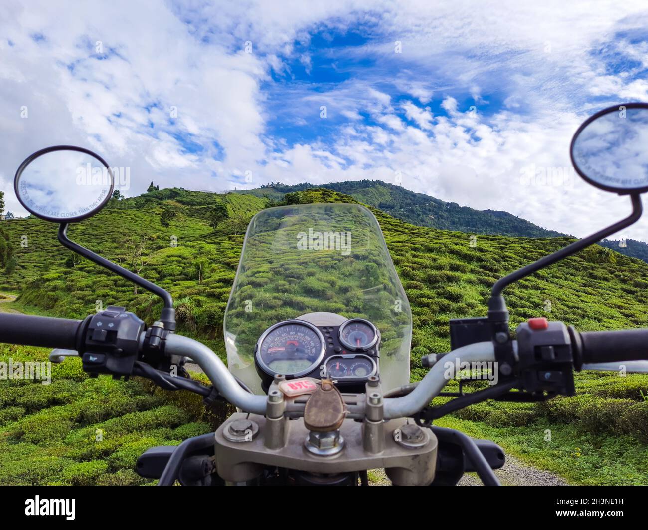 motorcycle front view at tea garden with mountain view at morning Stock Photo
