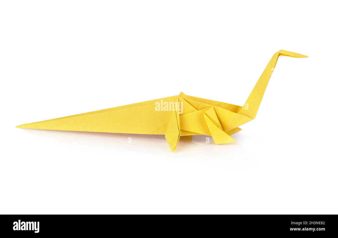 Yellow origami Diplodocus isolated over white background Stock Photo