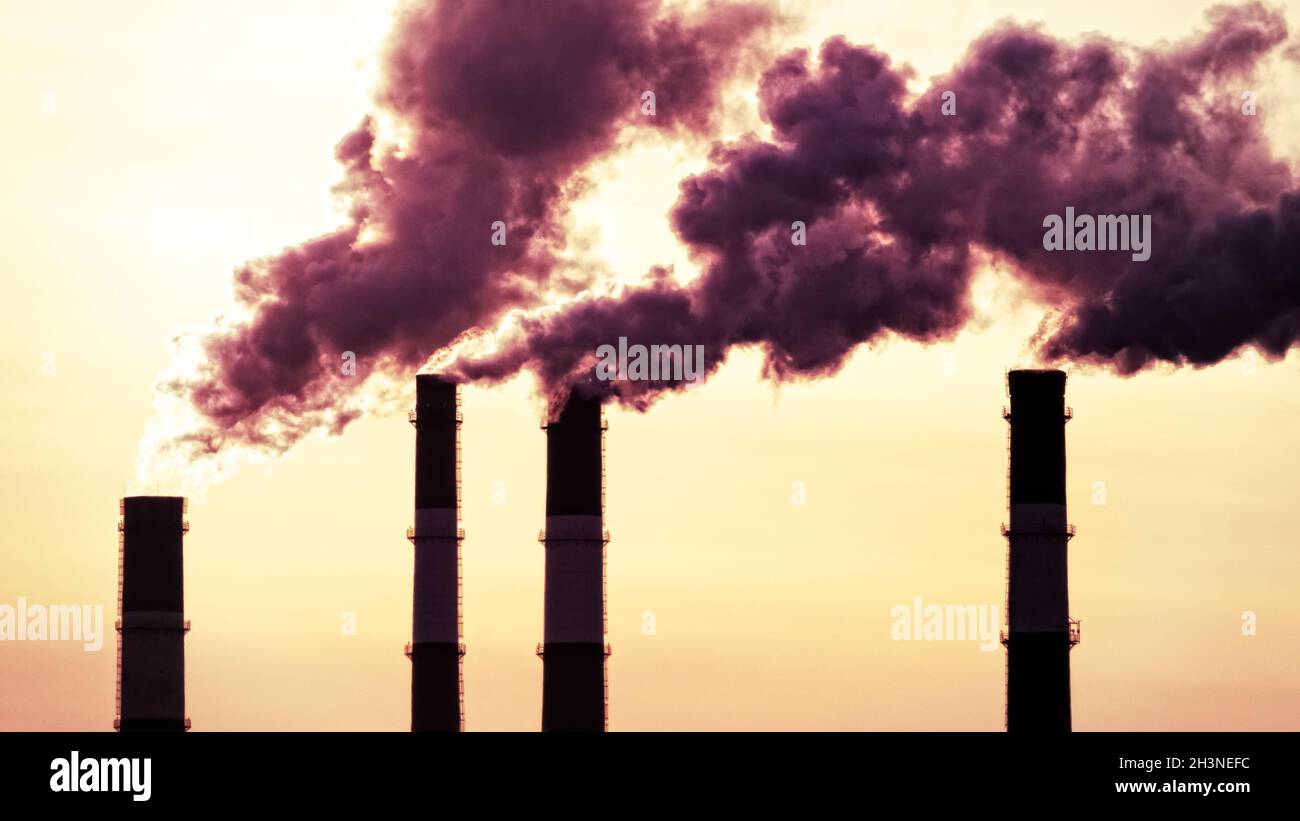 Spring, morning rising sun and smoking plant pipes Stock Photo - Alamy