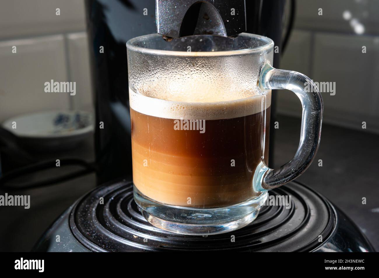 Still steaming freshly brewed cup of coffee. Different layers are