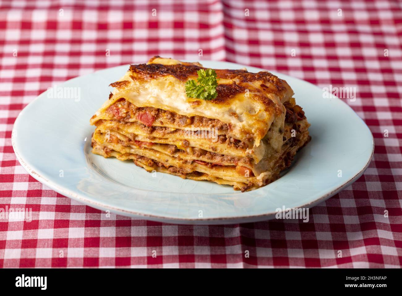 Portion of fresh lasagne on a plate Stock Photo Alamy
