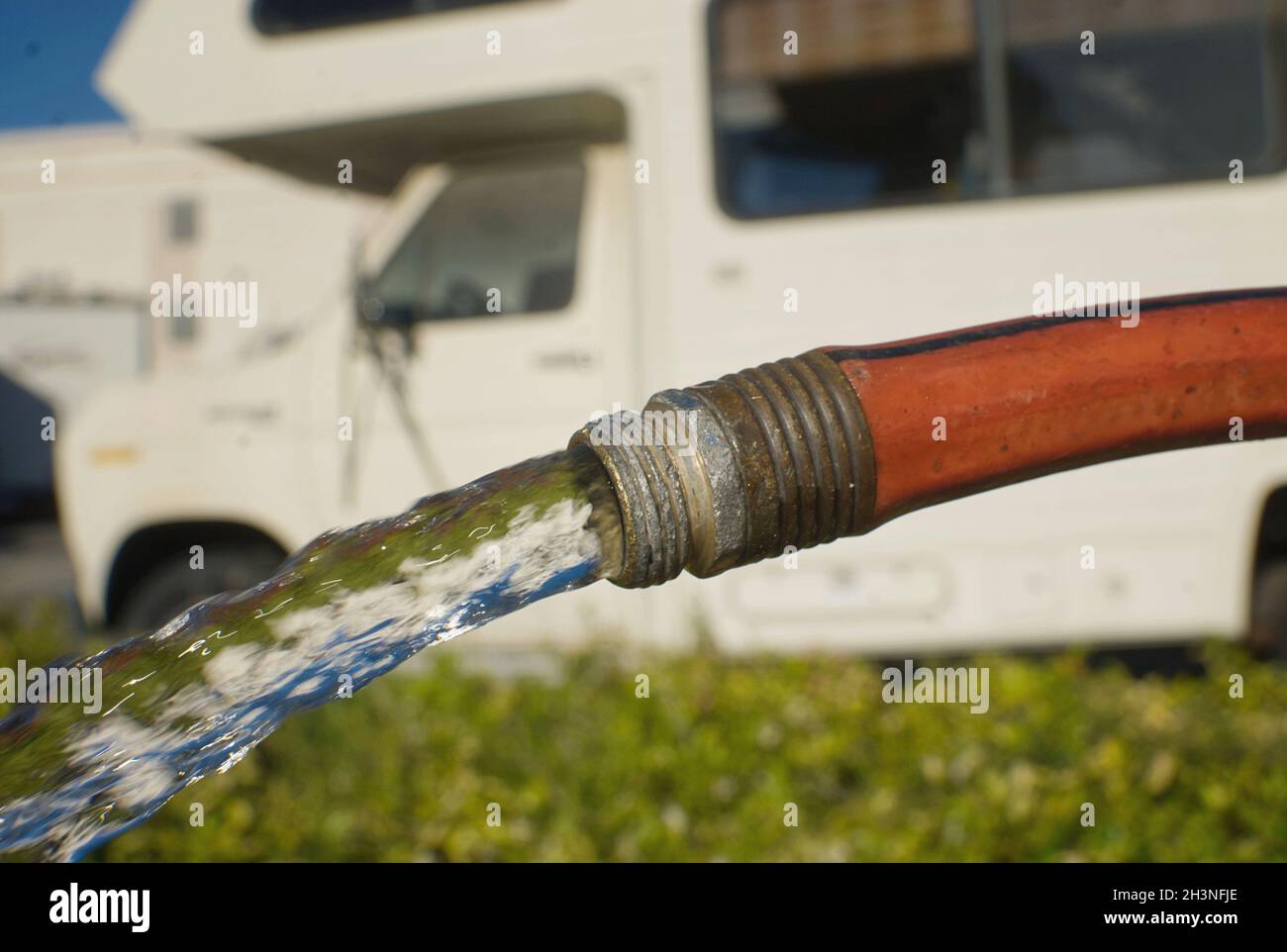 Hose water and a camper Stock Photo Alamy