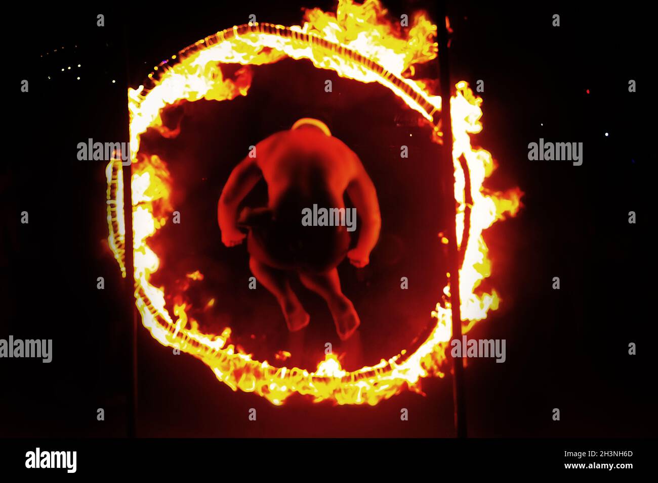 A man passes in a circle of fire Stock Photo