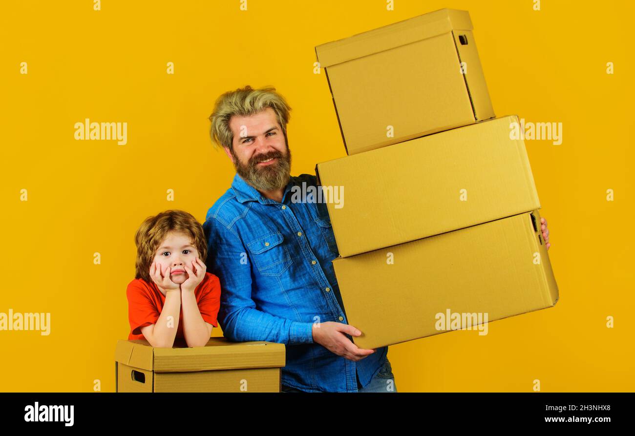 Father and son with carton boxes. Prepare for moving. Family and new home concept. Packaging things. Stock Photo