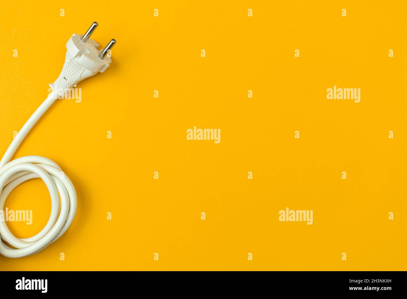 Electrical power cable with EU plug on a flat orange background, top view, copy space Stock Photo