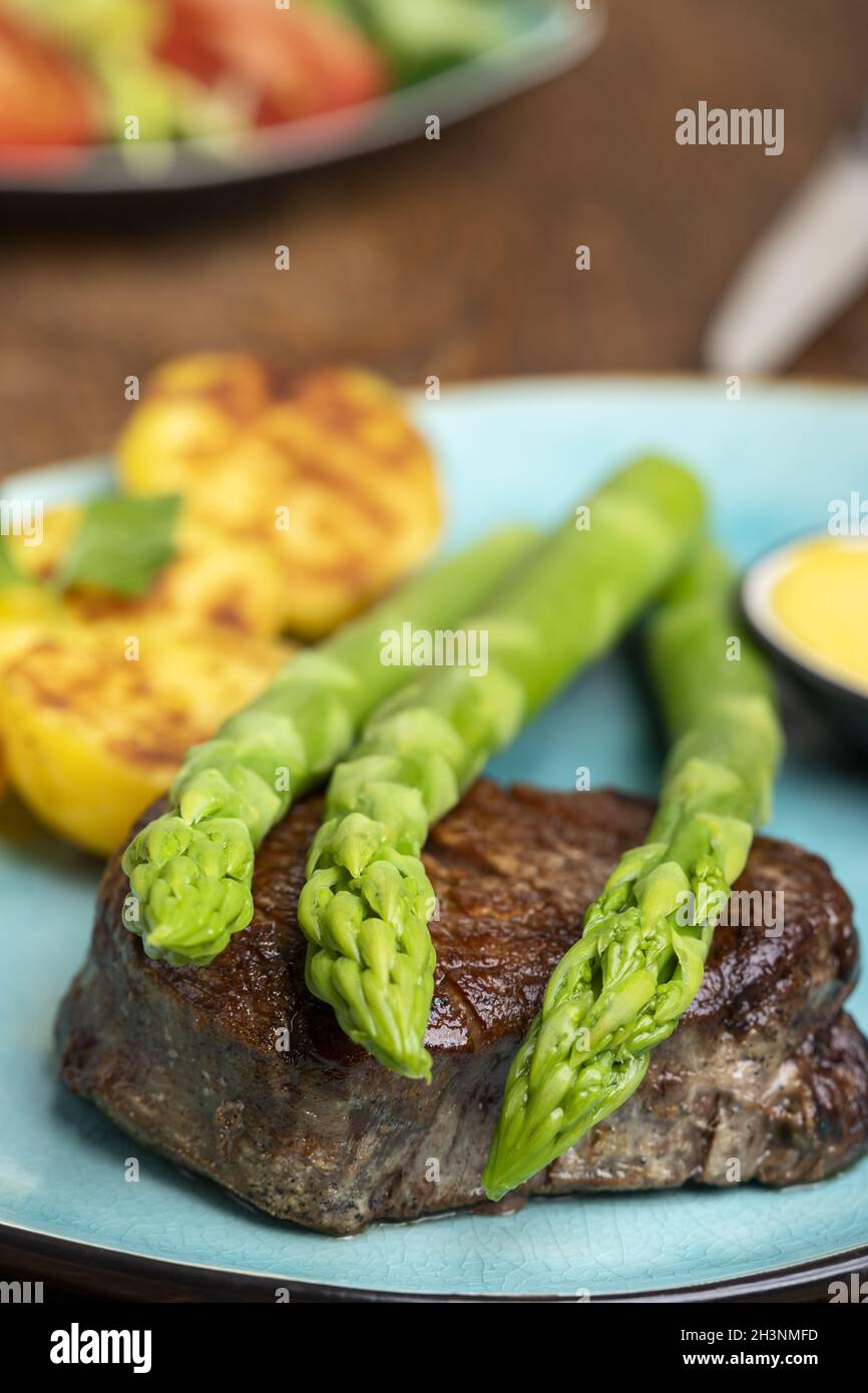 Asparagus with potatoes and a steak Stock Photo
