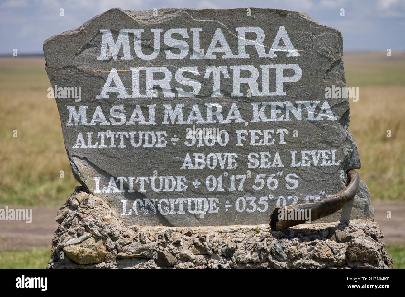 Musiara airstrip stone sign with details of location and altitude, Masai Mara, Kenya Stock Photo
