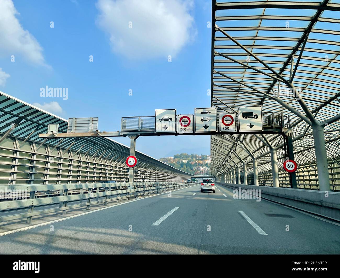 Como, Switzerland, 23.10.2021. Traffic on Swiss highway with noise barriers close to border crossing Como Chiasso, Italy. Stock Photo
