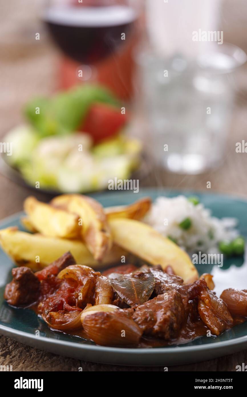 Greek stifado meat stew with french fries Stock Photo Alamy