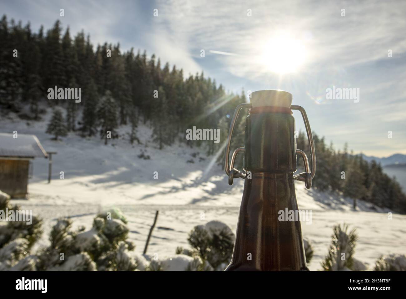 Beer bottle outdoors in winter Stock Photo