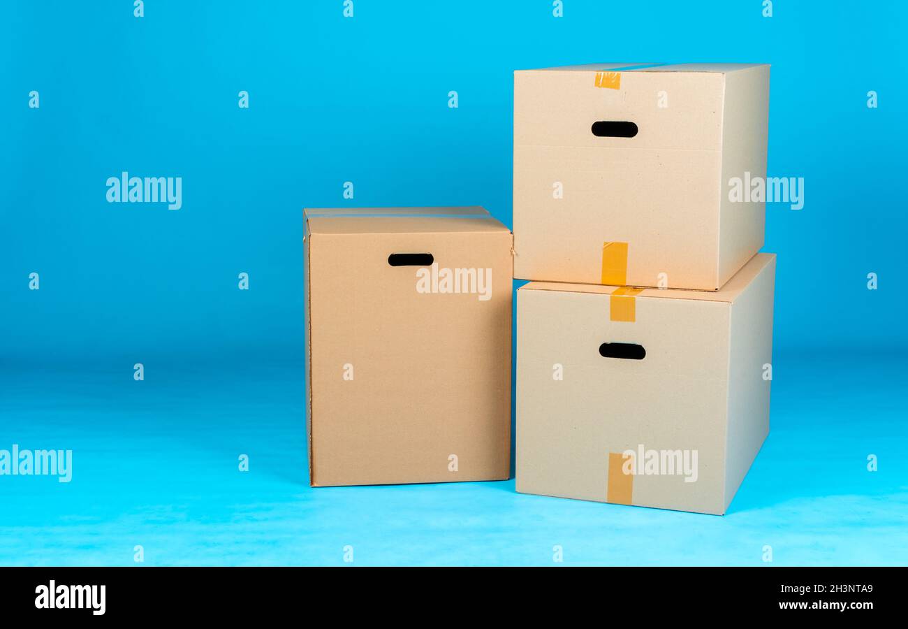 Material Stacking Blue Box Stack of cardboard boxes on blue background Stock Photo - Alamy