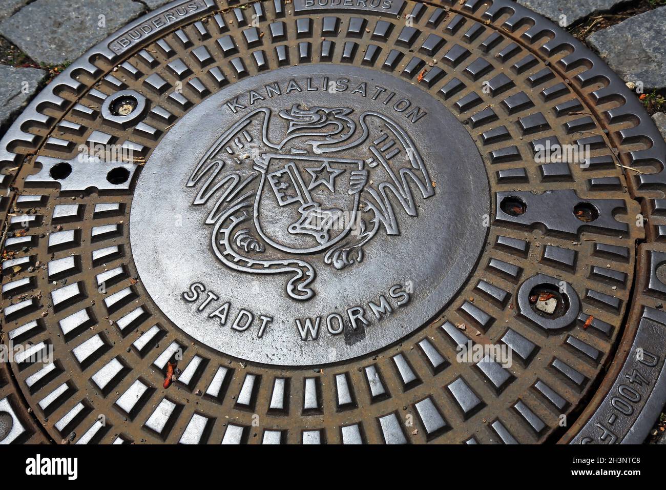 Manhole cover with coat of arms of Worms Stock Photo