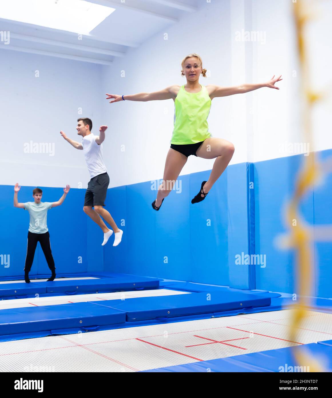 Woman jumping in trampoline center Stock Photo Alamy