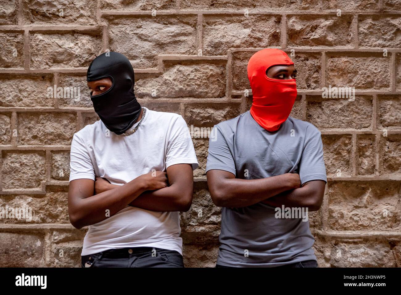 Two afro young men in ski masks in alleyway Stock Photo - Alamy