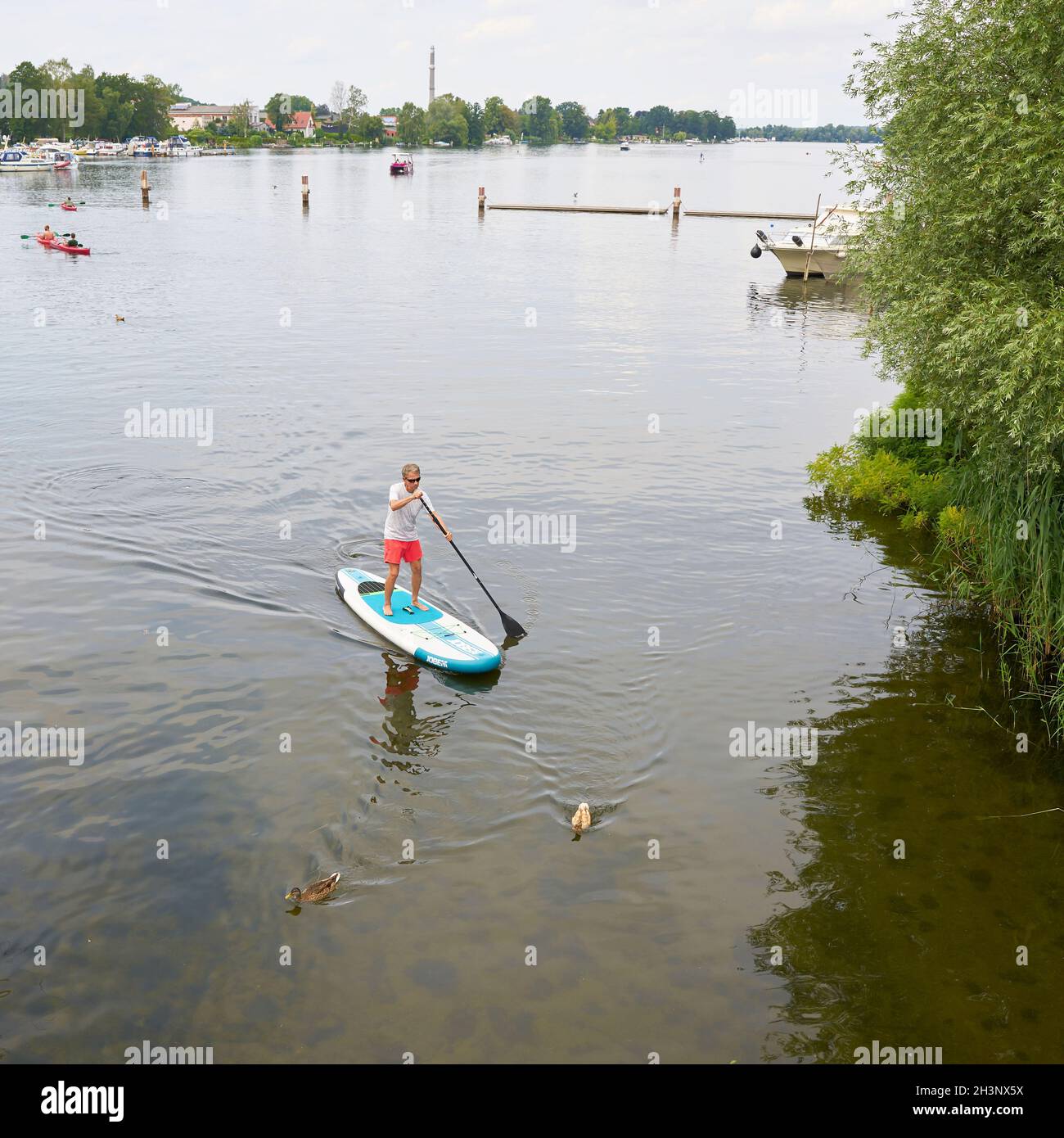 Stand-up paddling on the river Havel near Werder seen from a bridge Stock Photo