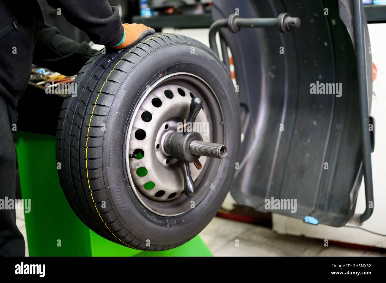 Mechanic balancing a car wheel Stock Photo