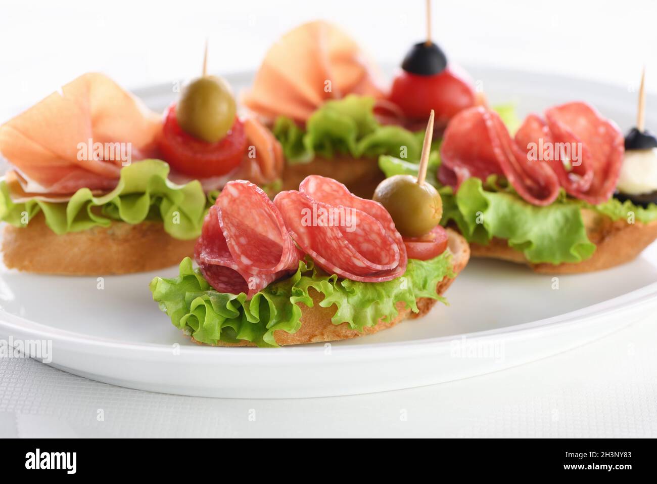 Tender baguette canapes with Leaf lettuce, salami or Parma ham