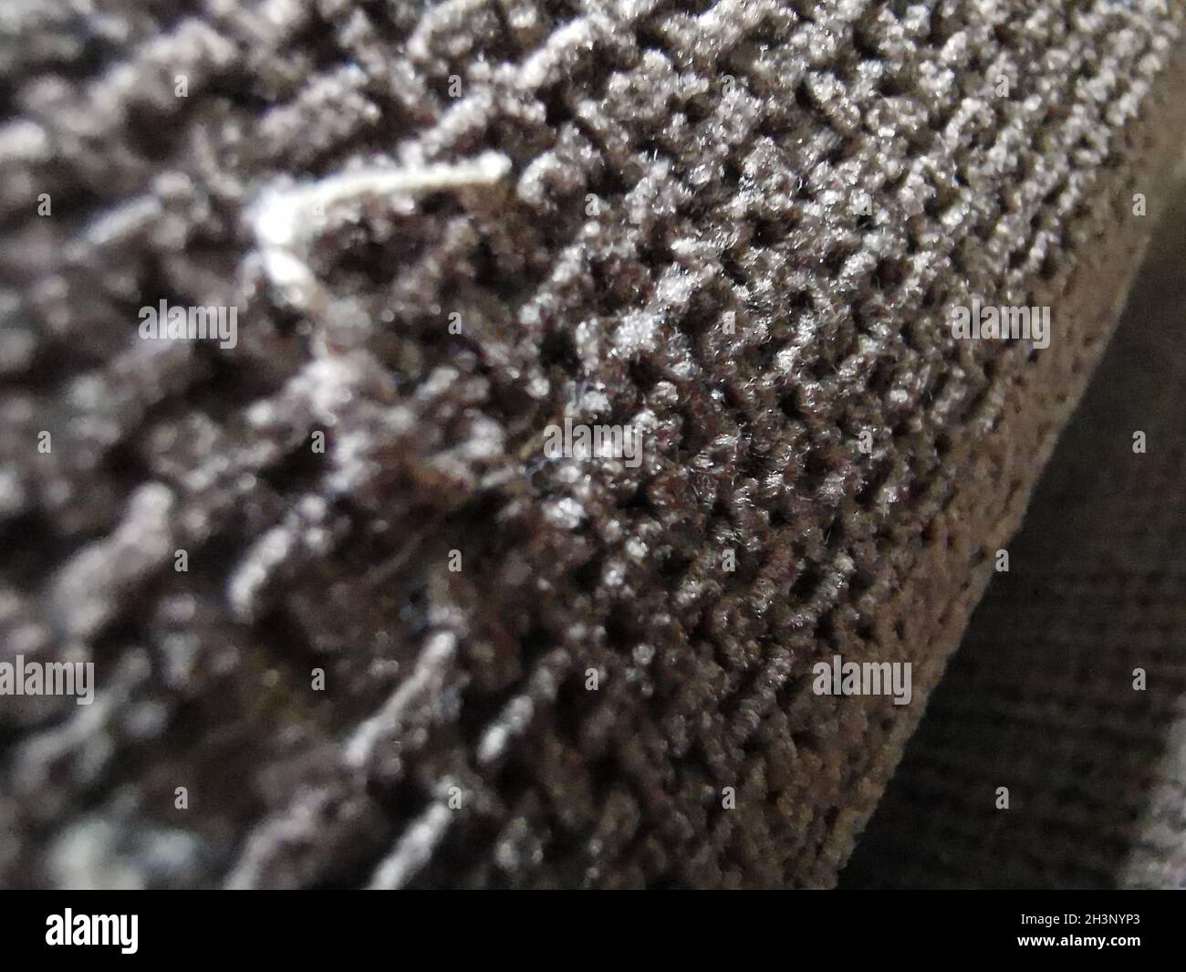 Under of a floor covering carpet. Close up photo. Stock Photo