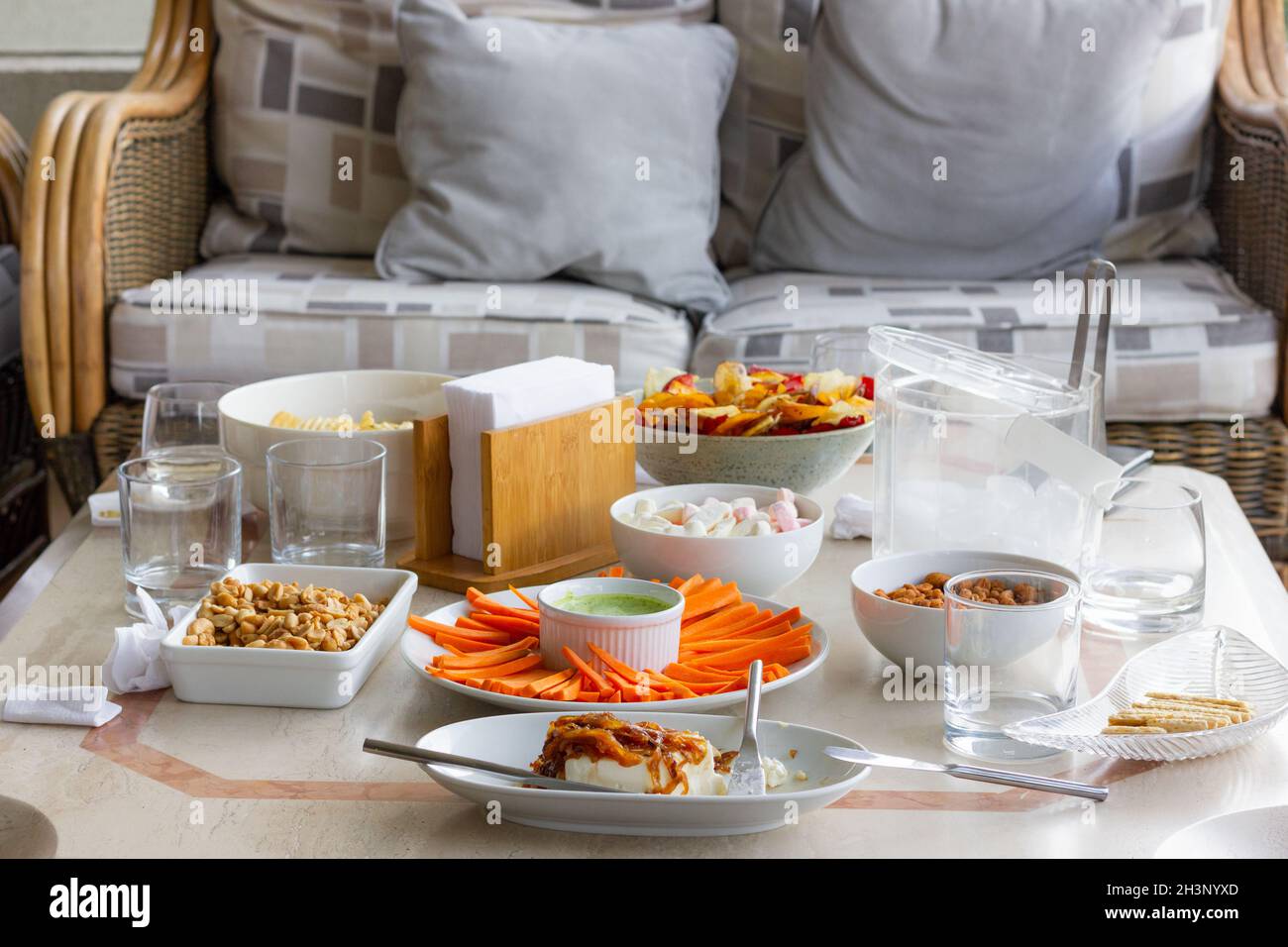 Variety of salty and healthy snack on table. Home terrace picnic ...