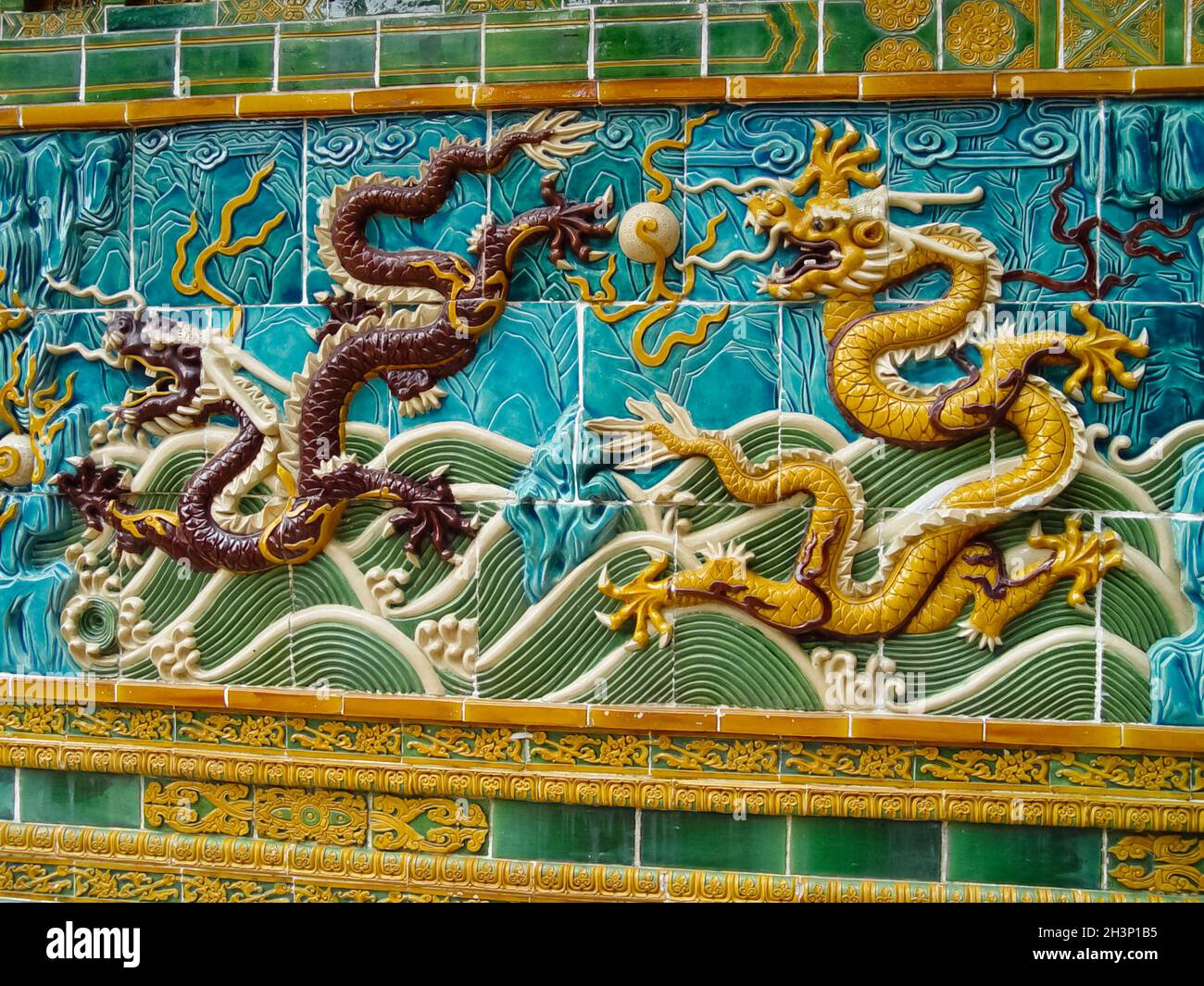 Mosaic of dragons on Chinese sarcophagus. Decorations made of tiles. Stock Photo
