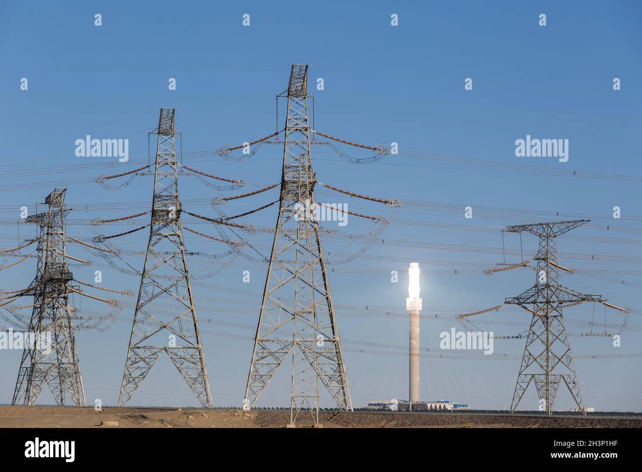 Molten salt tower closeup and power transmission tower Stock Photo
