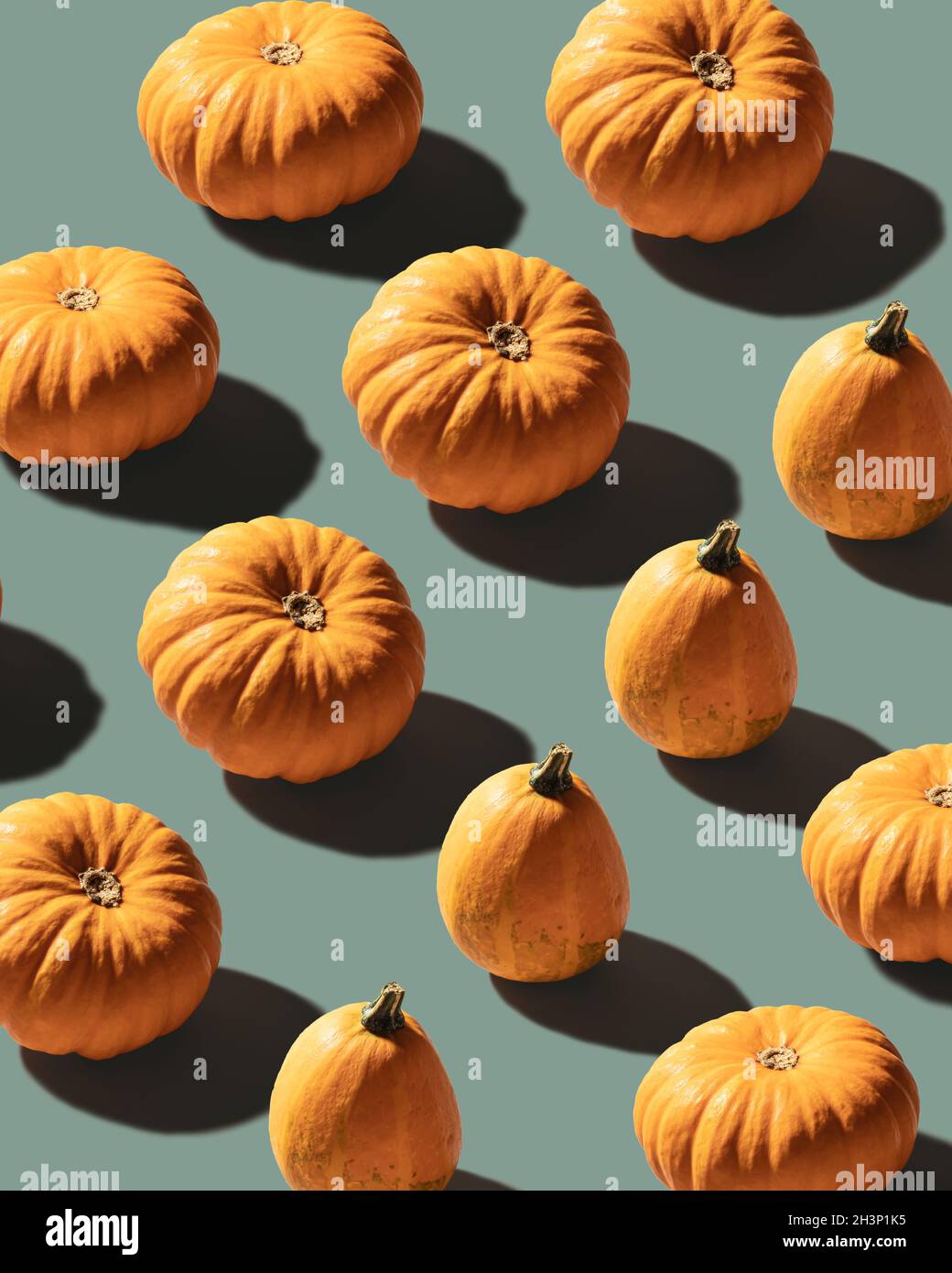 Pumpkins patterned over blue background Stock Photo