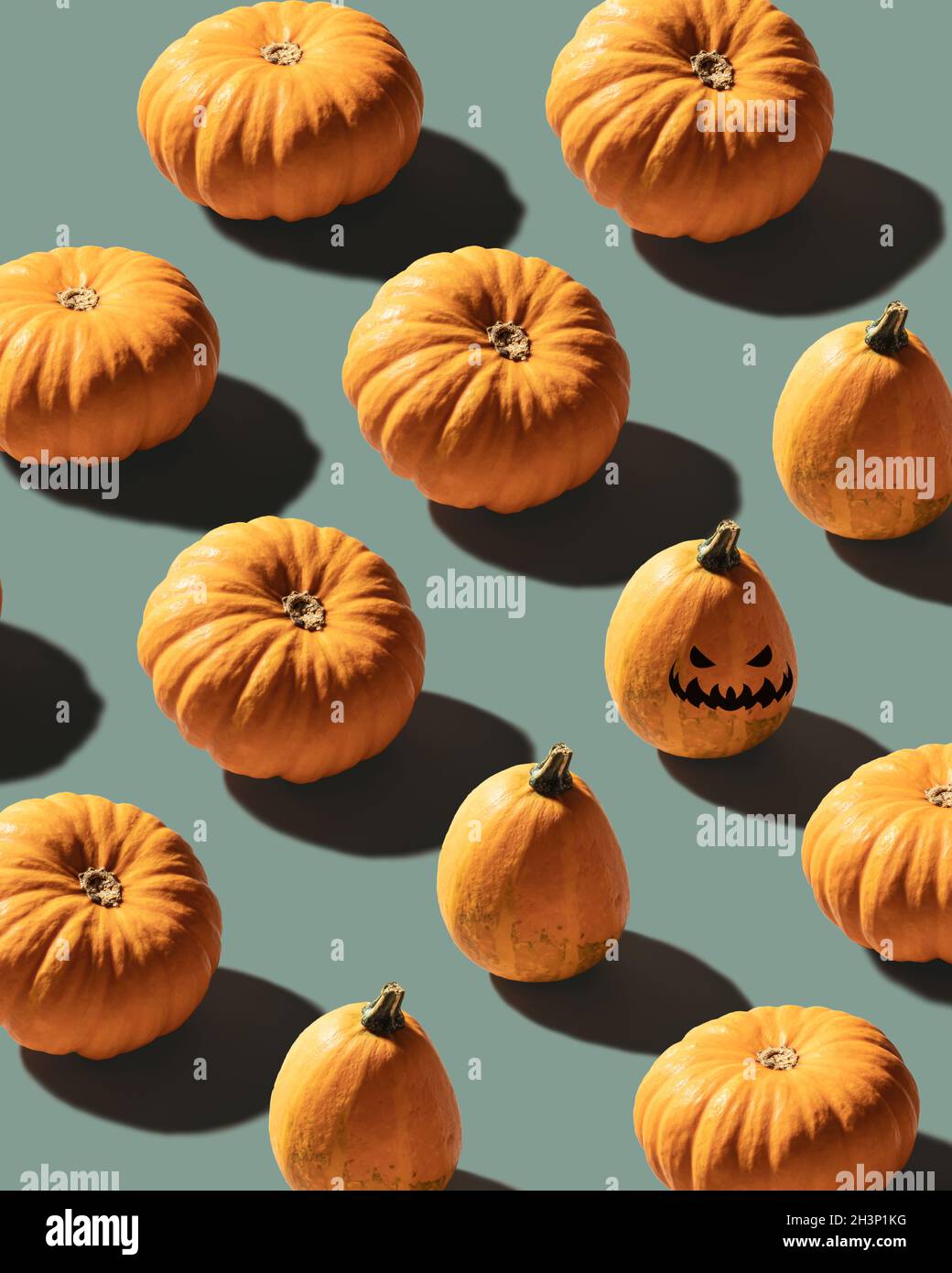 Pumpkins patterned over blue background with evil laughing pumpkin Stock Photo