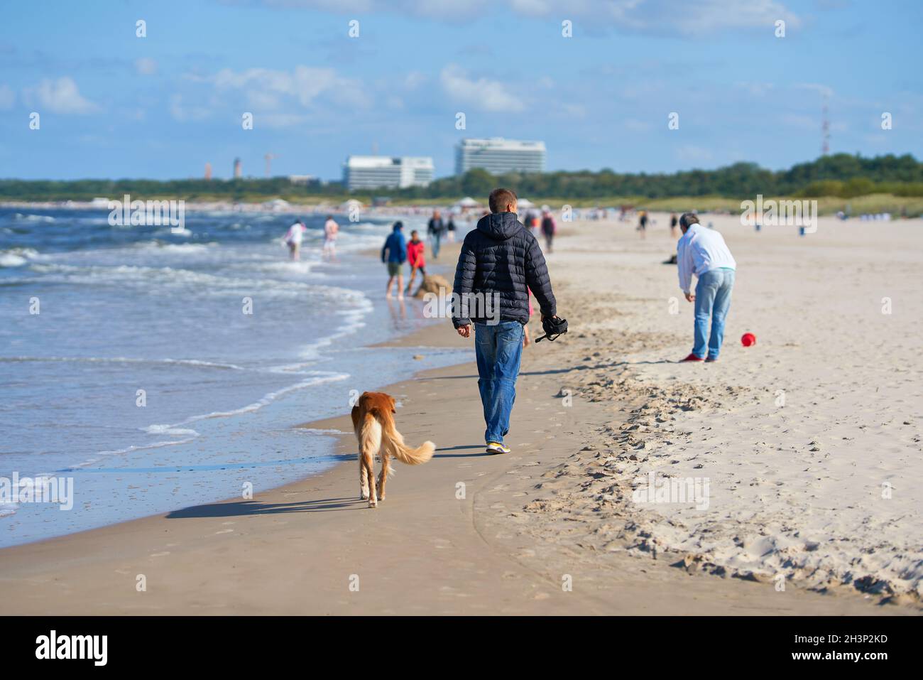 Tourists walking on the beach of Swinoujscie on the Polish coast of the Baltic Sea Stock Photo