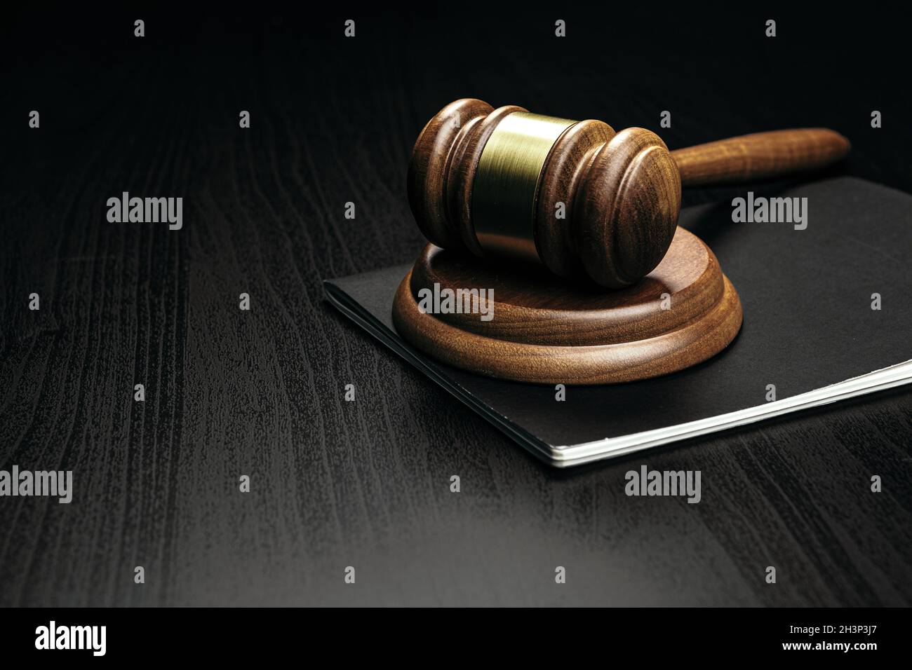 Image of wooden judge hammer on notepad Stock Photo