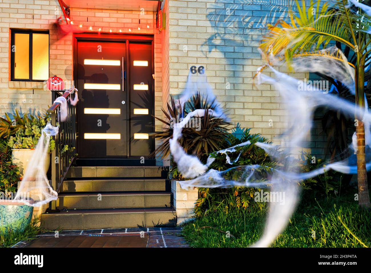 Halloween celebration and decoration of a residential house in Sydney suburb with lights and spider webs. Stock Photo