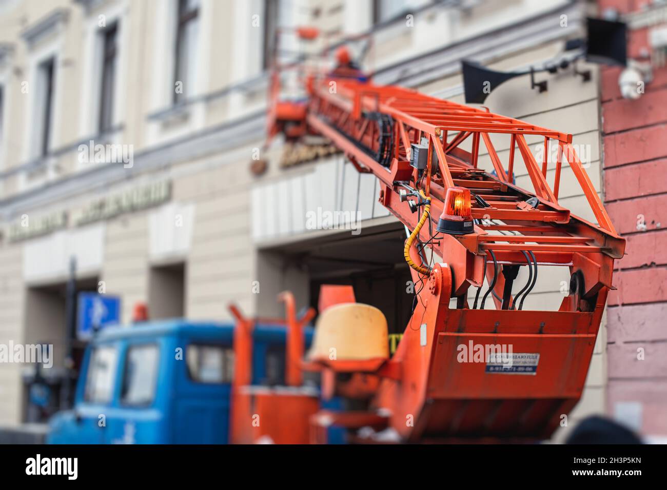 Aerial work platform vehicle during facade decoration, orange