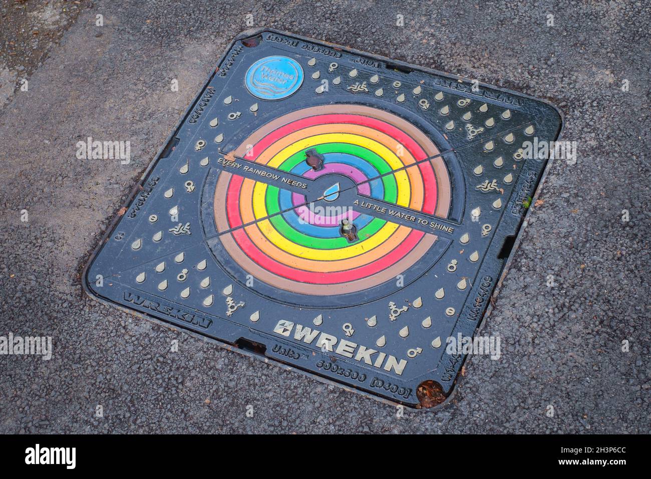 A special commemorative cast iron Thames Water 'Rainbow' manhole cover marked 'Every Rainbow needs a little water to shine' Stock Photo