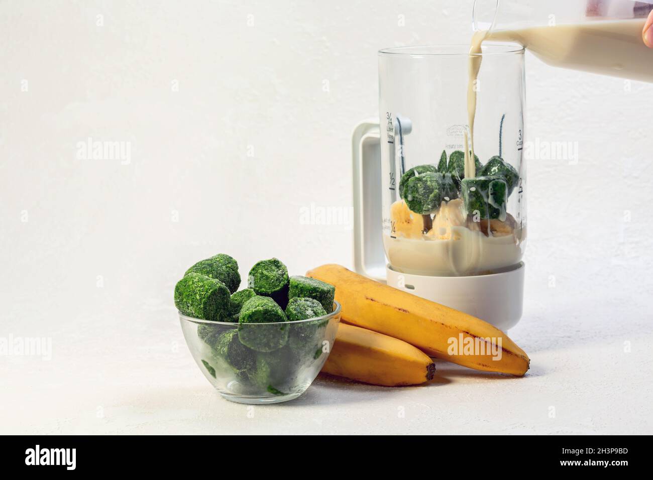 Making smoothies from frozen spinach Stock Photo Alamy