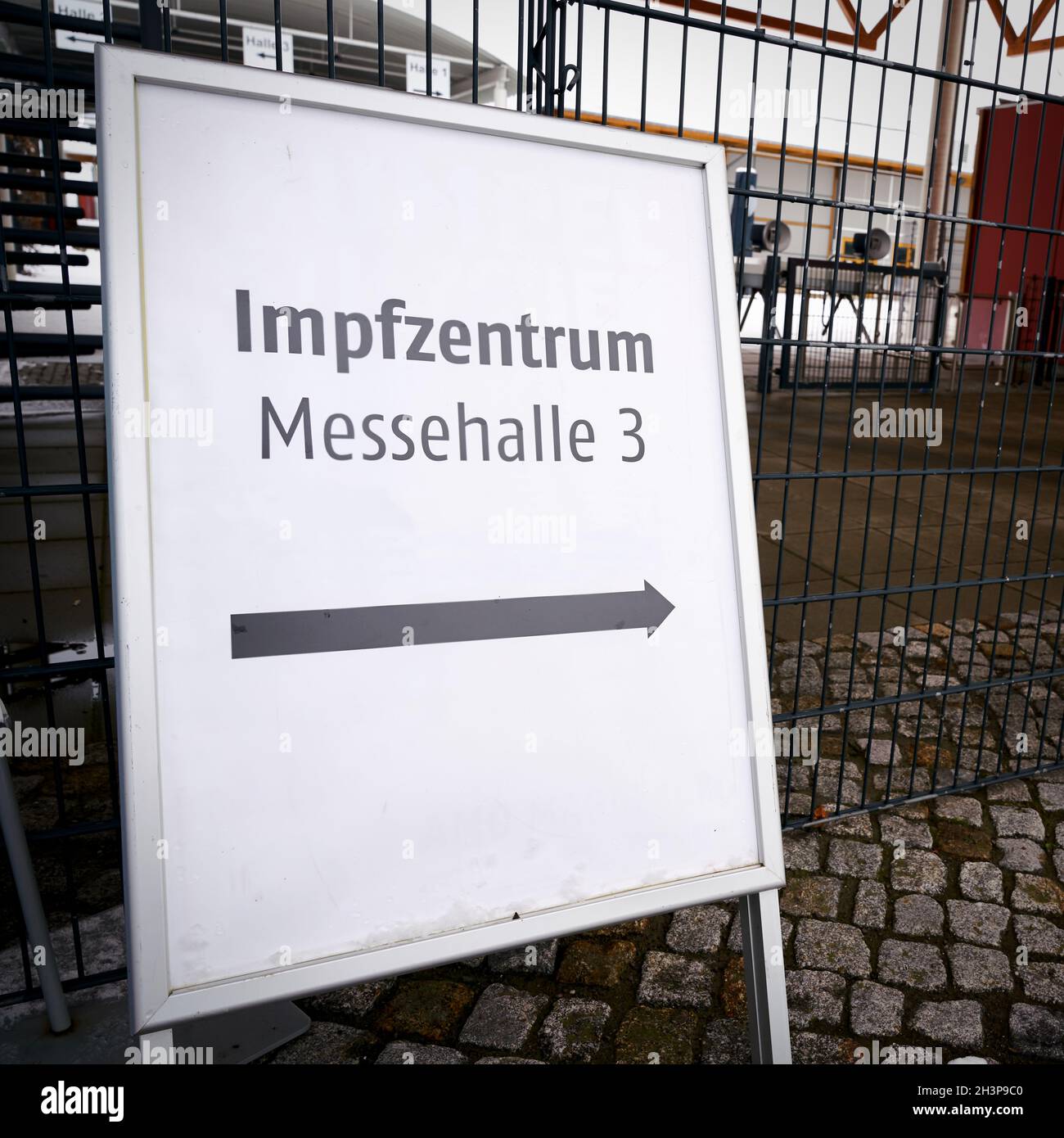 Sign with the inscription vaccination center (Impfzentrum) in exhibition hall 3. Stock Photo