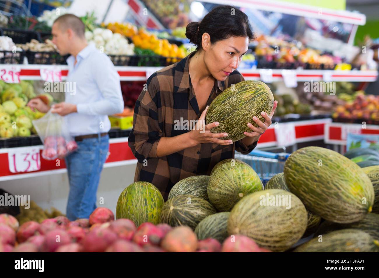 Asian person buying melon hires stock photography and images Alamy