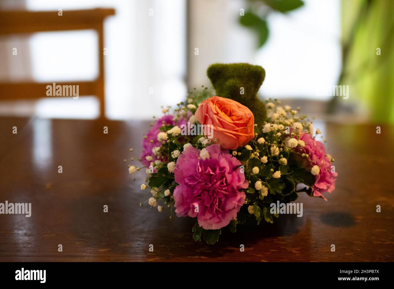 Green grass-made teddy bear with flowers from a banquet hall in Japan Stock Photo
