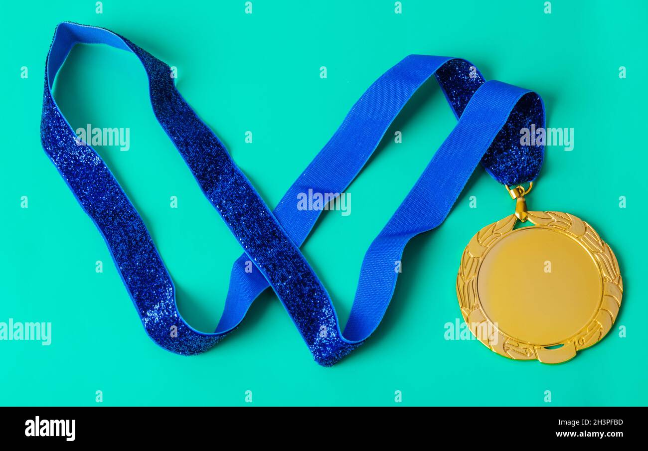 Gold medal on green Stock Photo