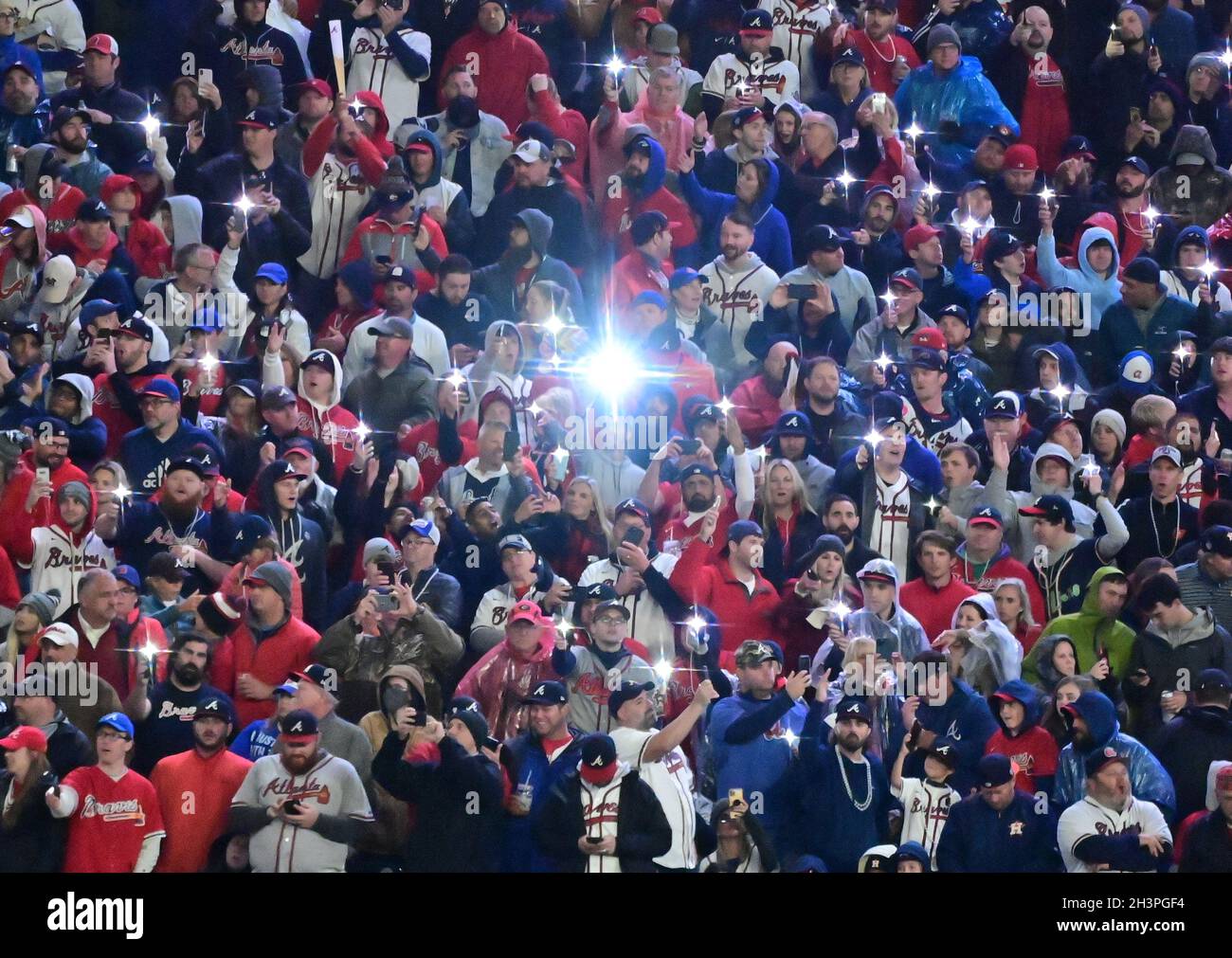 A Atlanta Braves fan does the tomahawk chop cheer during the first inning  in Game 3 of baseball's World Series between the Houston Astros and the Atlanta  Braves Friday, Oct. 29, 2021