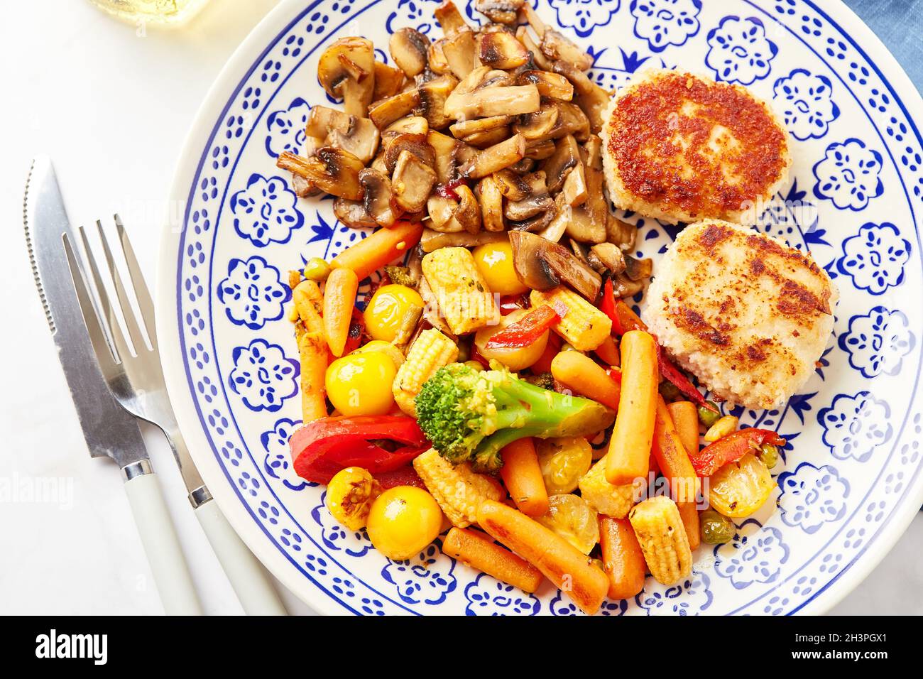 Plate with fried vegetables, carrots, broccoli, baby corn, bell peppers