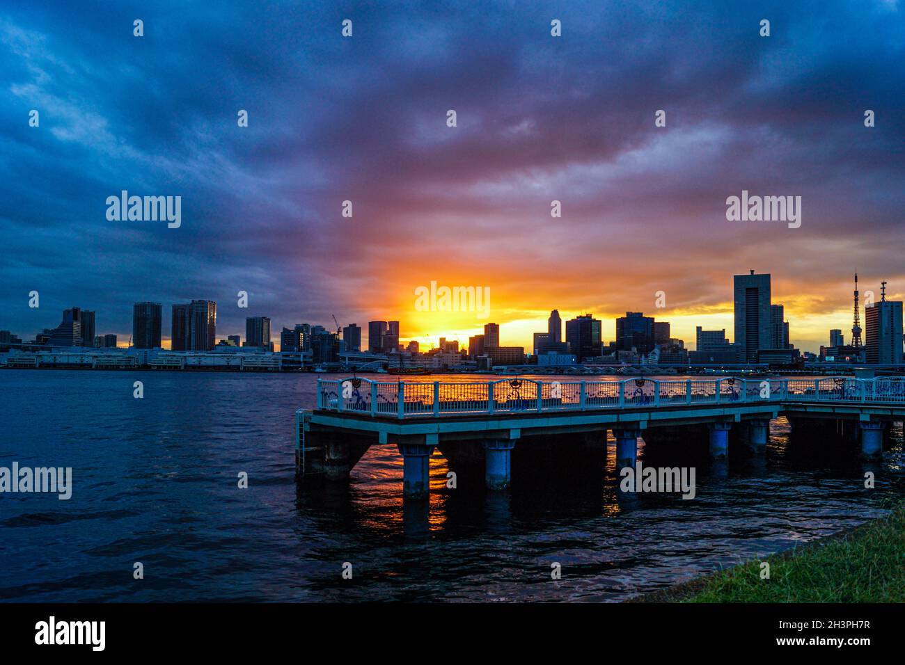 Tokyo skyline and sunset as seen from Harumi Pier Stock Photo