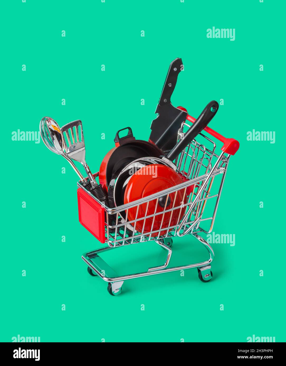 Toy kitchenware in shopping cart Stock Photo
