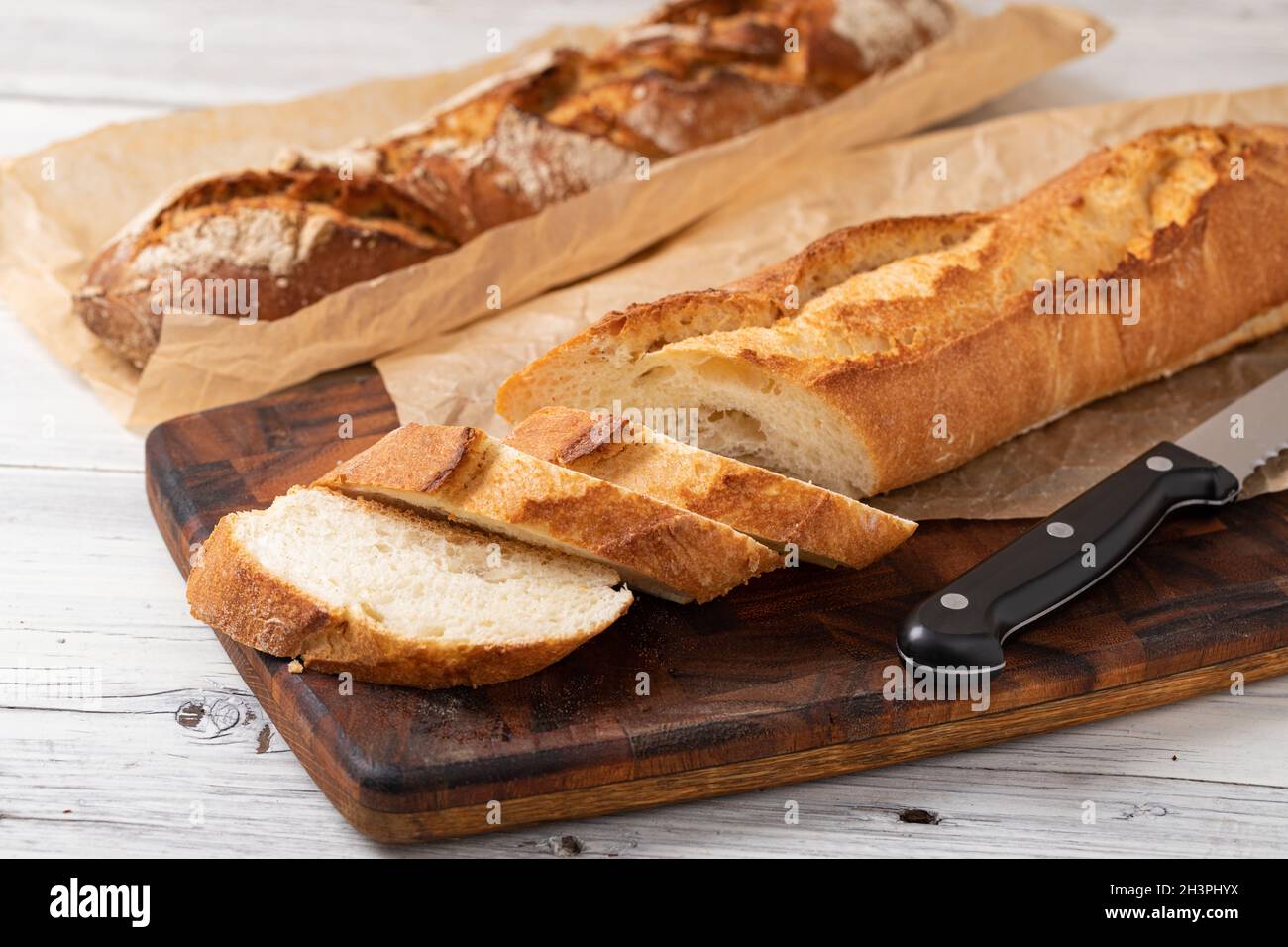 Baked bread on wooden table Stock Photo