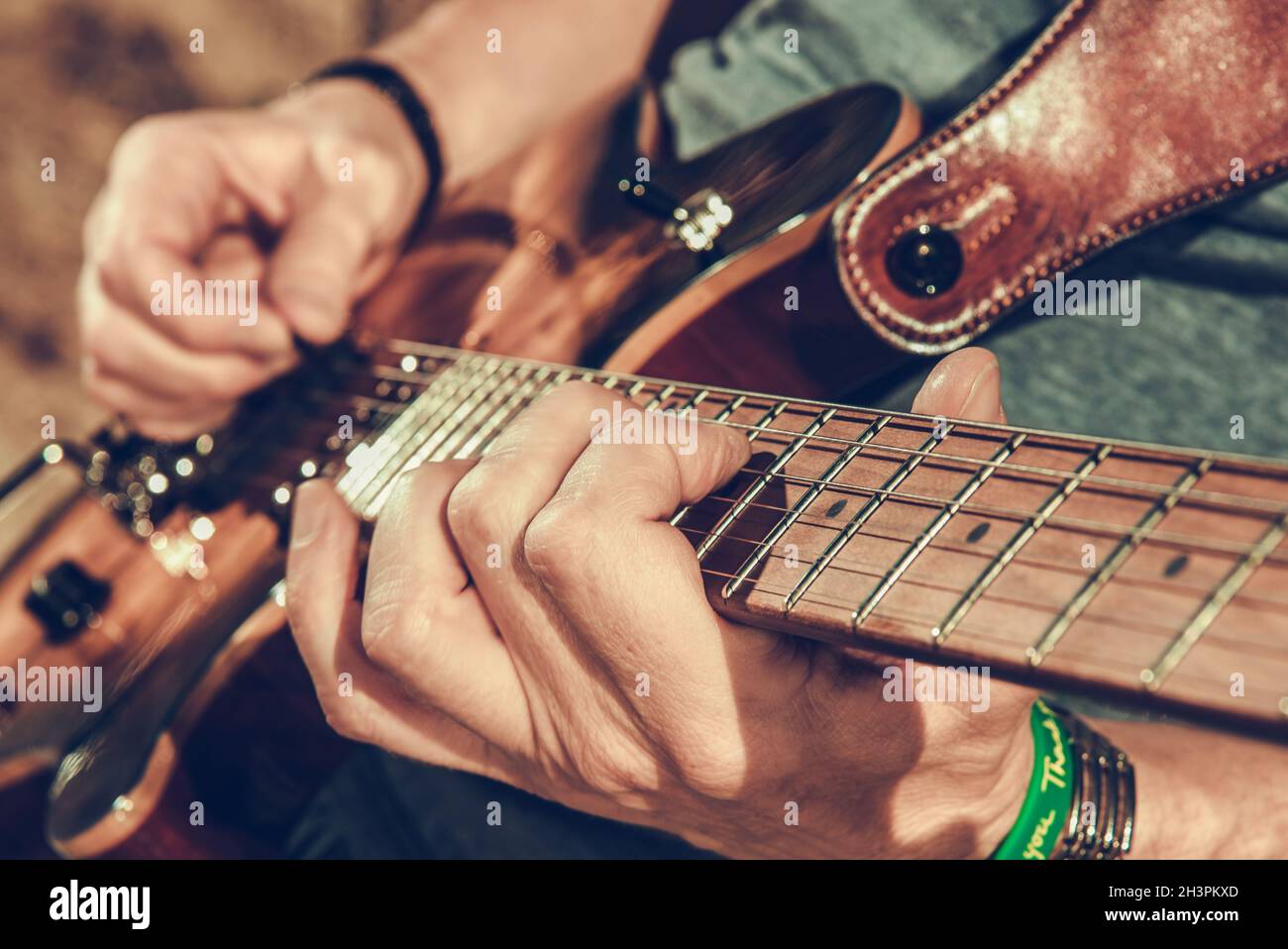Caucasian Musician Playing Electric Guitar Close Up Photo. Music and