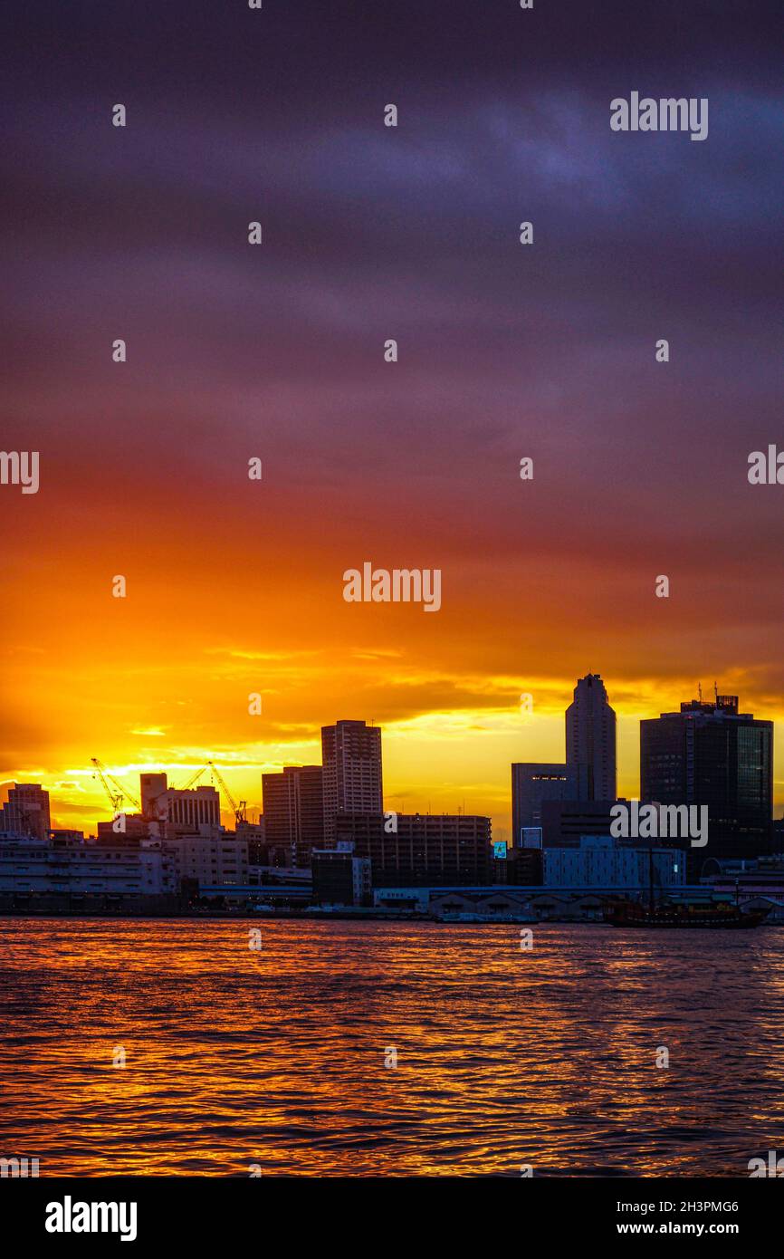 Tokyo skyline and sunset as seen from Harumi Pier Stock Photo