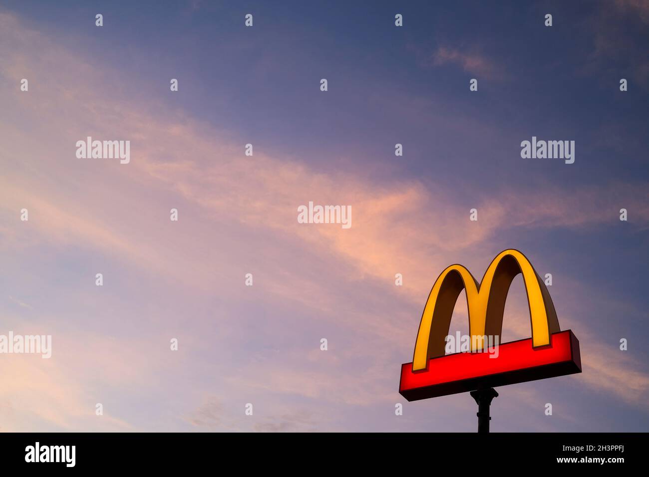 The MacDonald golden arches logo at sunset Stock Photo