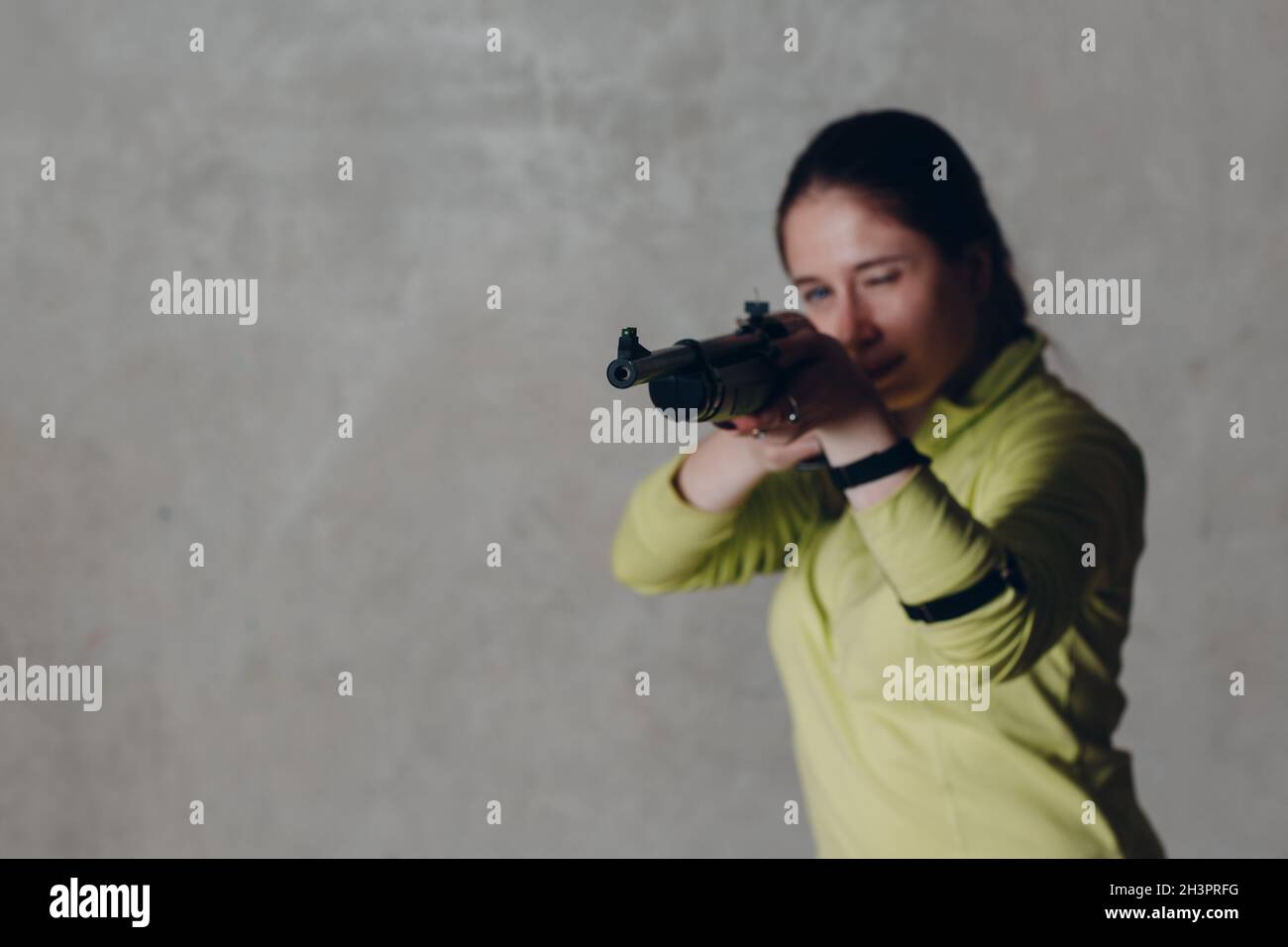 Young adult woman with rifle. Self defence concept Stock Photo