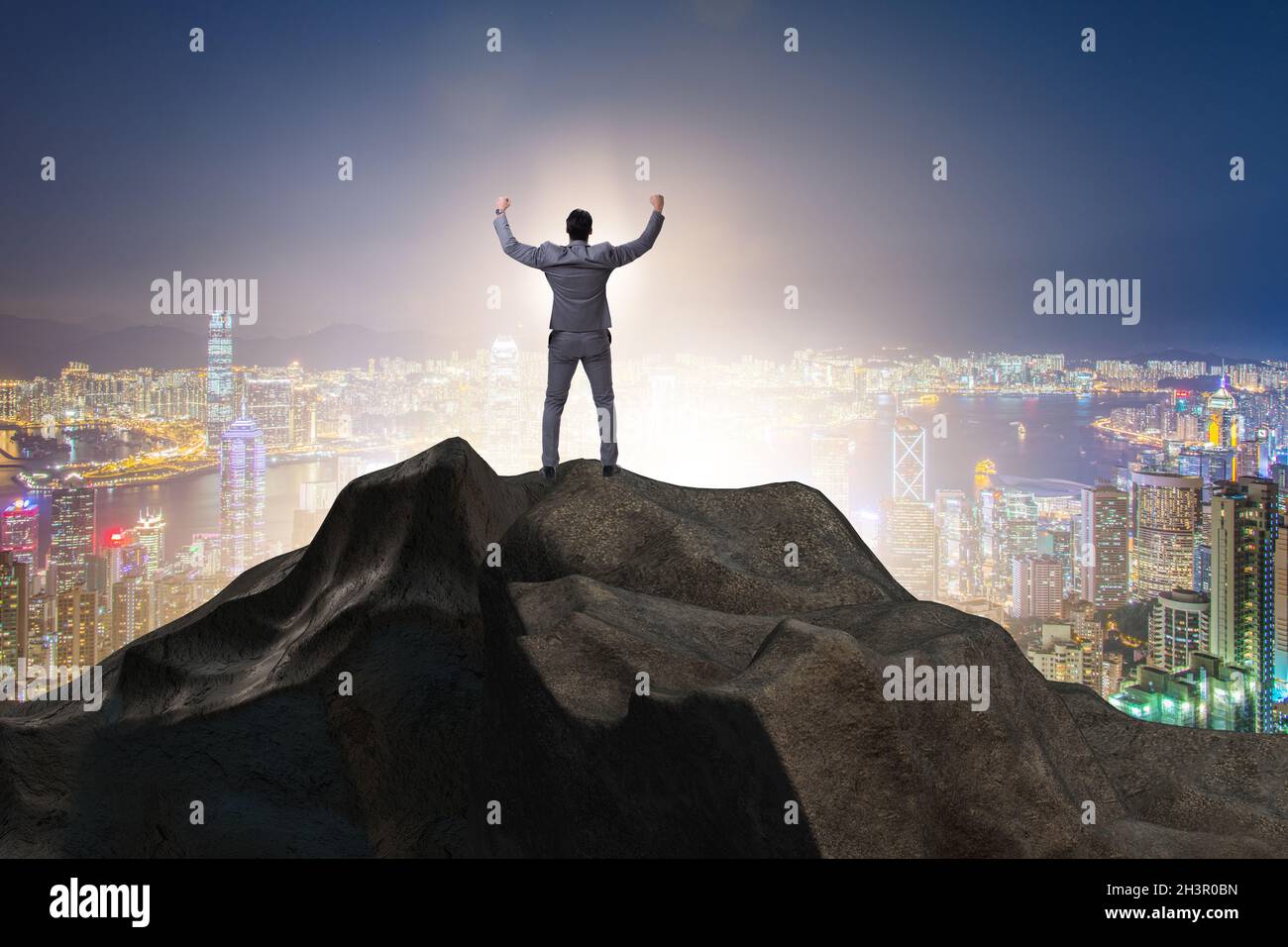 Businessman at the top of mountain in career concept Stock Photo - Alamy