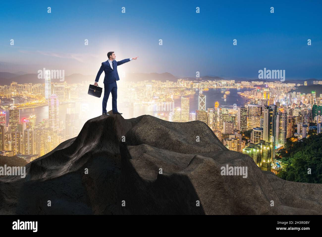 Businessman at the top of mountain in career concept Stock Photo - Alamy