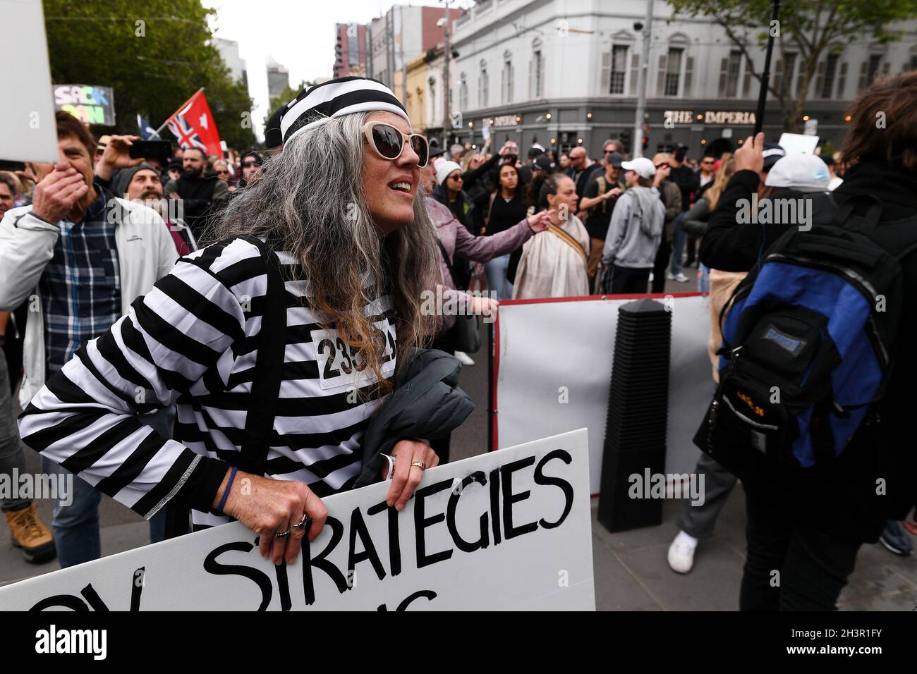 Melbourne, Australia, 30 October, 2021. A Protester in a prisoner costume on the steps of State Parliament during the 'Rise Up! Melbourne Rally' in the CBD to protest vaccine mandates and the proposed laws in state parliament that will allow police to jail anti-lockdown protesters for up to two years. Credit: Michael Currie/Speed Media/Alamy Live News Stock Photo