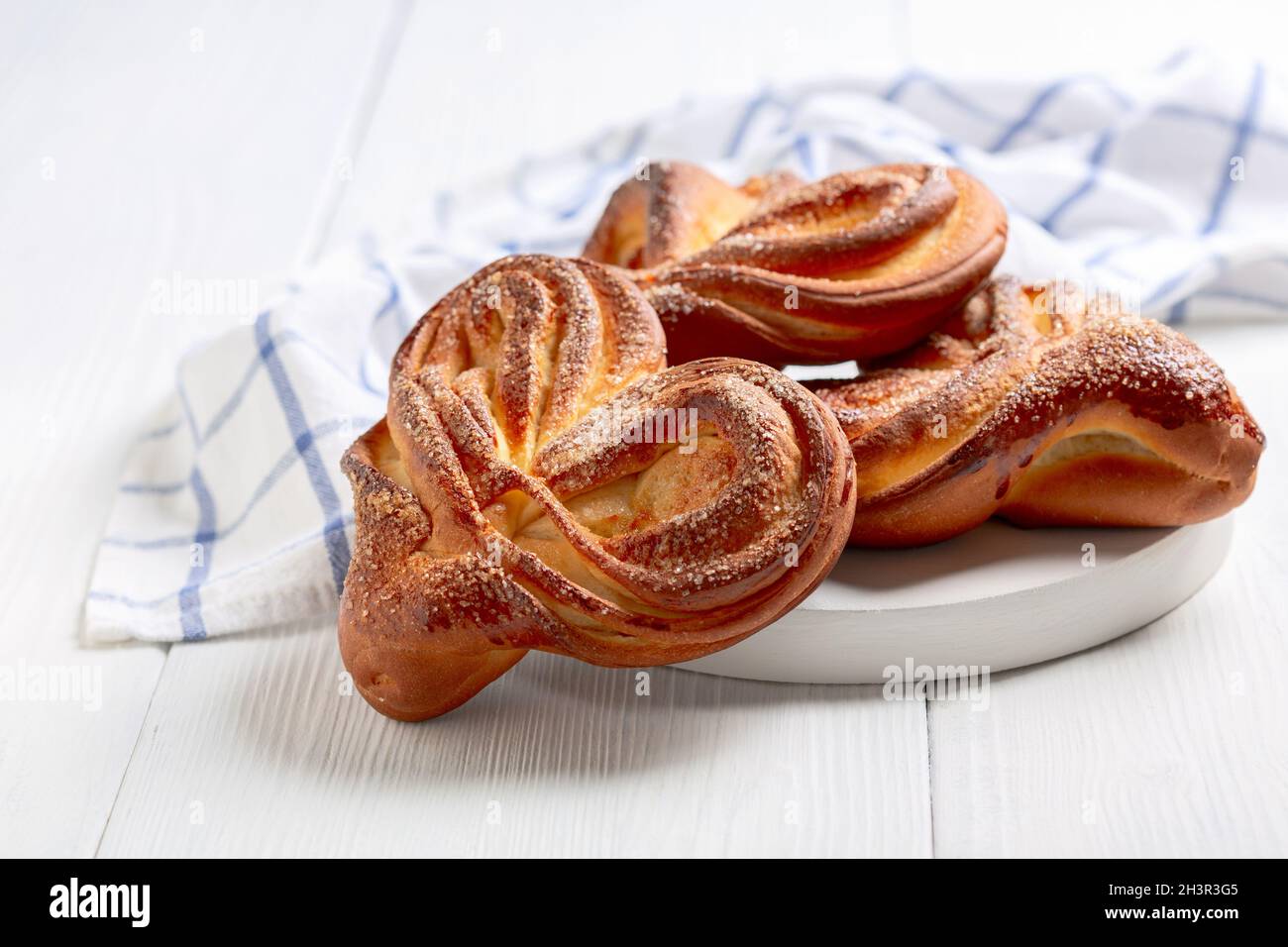 Sweet swirling buns sprinkled with sugar. Stock Photo